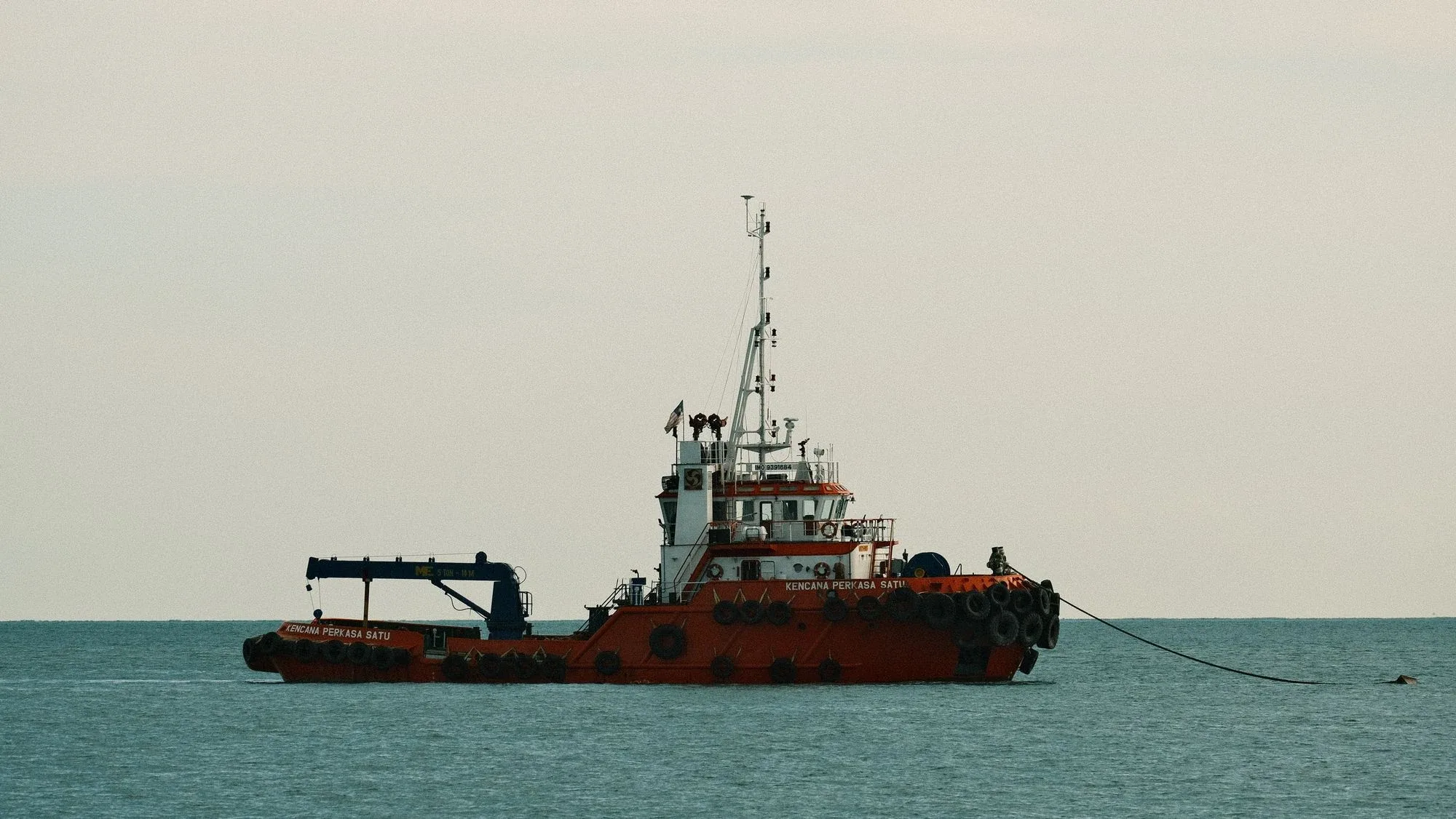 Kapal tunda di perairan pesisir yang tenang